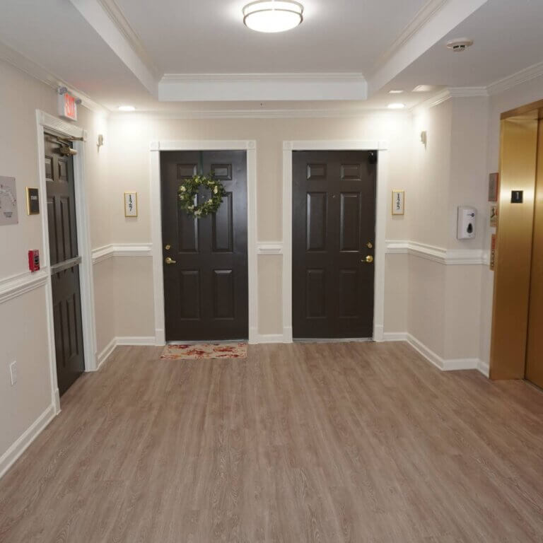 refreshed interior hallway and elevator bay at Columbia High Point Senior Apartments in Atlanta GA